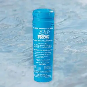 A blue cylindrical container labeled Frog Mineral Cartridge stands upright on a light blue, watery background. The label indicates its for spa water sanitation and displays usage instructions and brand information.