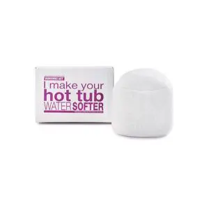 A white box labeled I make your hot tub water softer in purple text sits next to a large, white, cylindrical object, likely a water softener product.