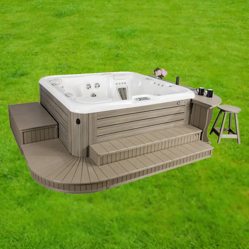 Hybrid hot tub surround featuring integrated steps, seating, and contemporary design, set on a grassy outdoor space.